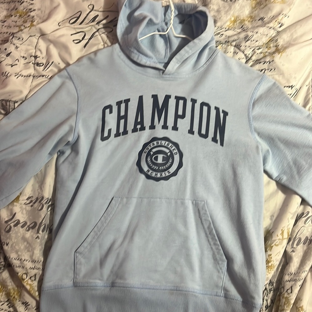Blue champion hoodie with stain on the bottom and on the sleeve not noticeable